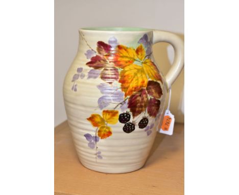 A CLARICE CLIFF WILKINSON LTD HANDLED MOULDED AND RIBBED VASE PAINTED WITH BLACKBERRIES AND BRAMBLES, moulded L/S to the base