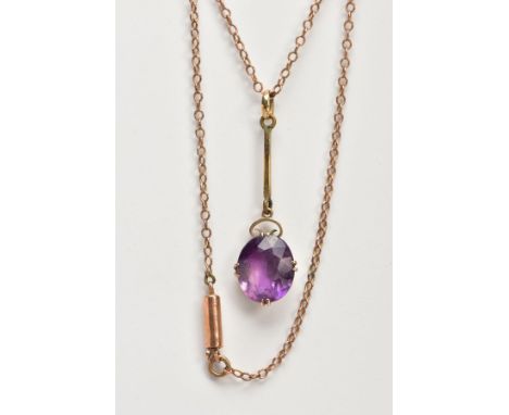 A YELLOW METAL AMETHYST PENDANT NECKLACE, designed with an oval cut amethyst dropper, double four claw set suspended from a p