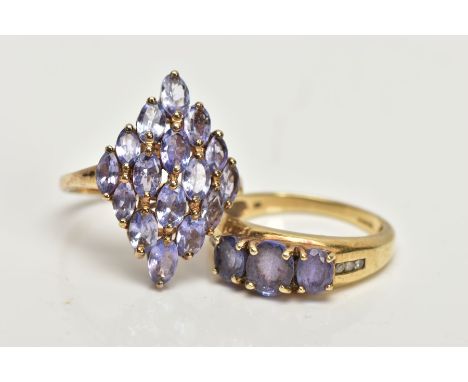 A 9CT GOLD TANZANITE RING AND A SILVER GILT RING, the first designed with three oval cut tanzanite's each four claw set, flan