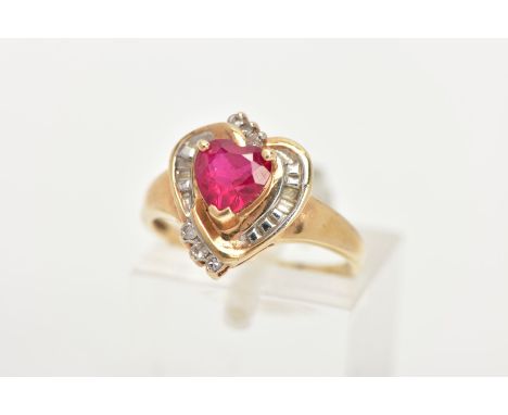 A YELLOW METAL GEM SET RING, of a heart design set centrally with a synthetic heart cut ruby, in a surround of tapered cut an