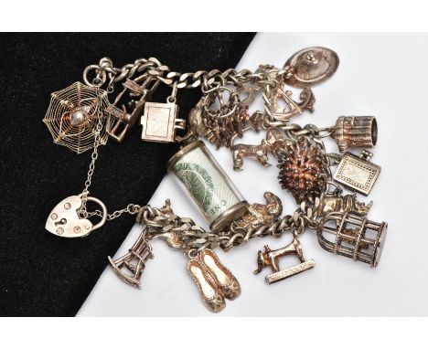 A SILVER CHARM BRACELET, curb link bracelet fitted with twenty charms in forms such as a money holder, bible, bird cage, poli