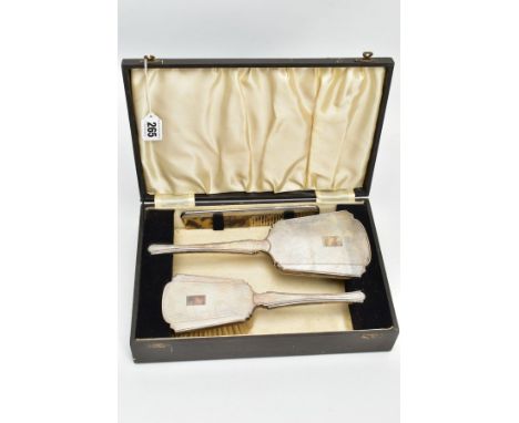 A CASED SILVER VANITY SET, black case which opens to reveal a hair brush, mirror and a comb, each with an engine turned desig