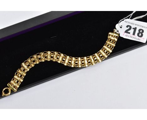 A YELLOW METAL FANCY LINK LINE BRACLET, designed with interlocking curb links interspaced with bar spacers, fitted with a lar