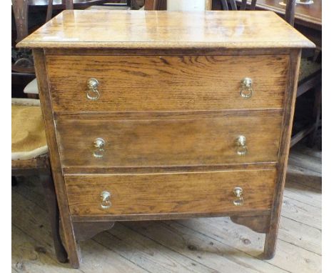 A vintage oak chest of three drawers on square legs