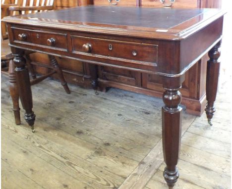 An inset leather top mahogany writing desk with two drawers