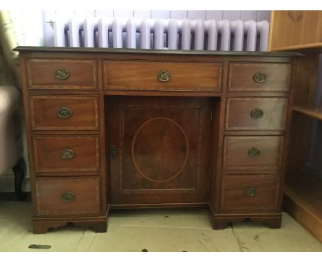 A 20th Century reproduction kneehole desk. four drawers to each side, central cupboard opening to reveal one shelf, mahogany 