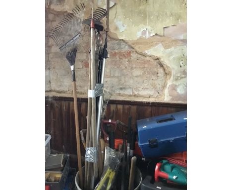 A metal bin containing a quantity of garden tools to include rakes, hoes, edgers, extendable lopers, wooden D handle spades, 