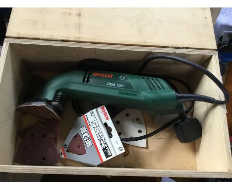 A Bosch PDA 100 sander with spare sanding pads