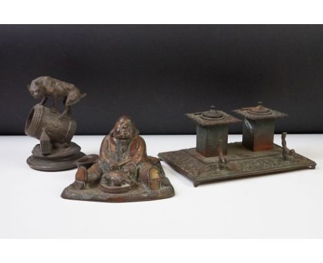 An antique metal standish with double inkwell together with a cast metal match striker in the form of a dog on barrel and an 