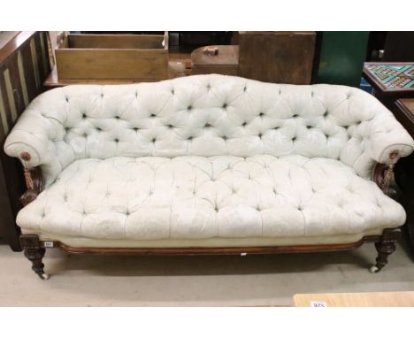 Victorian Walnut Framed Chesterfield Settee with pale blue button upholstery, shaped back, scrolling foliate carved arm suppo