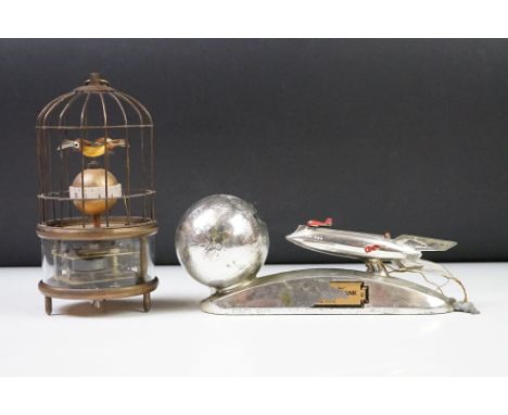 An atomic age Strato money box bank together with a wind up clock with turning caged birds. 