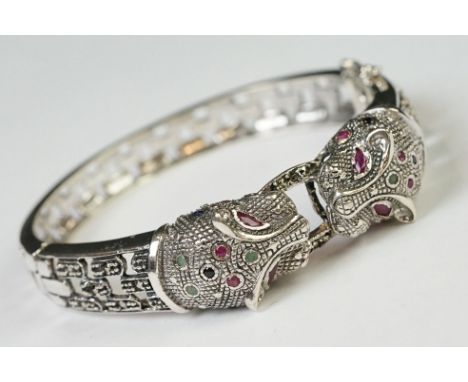 Silver hinged bangle in the form of leopards set with ruby eyes, designer style 