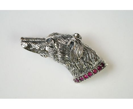 Silver dog brooch set on a ruby platform 