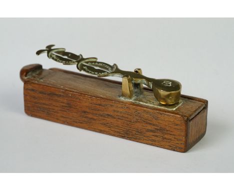 A set of antique brass sovereign scales within a wooden box. 