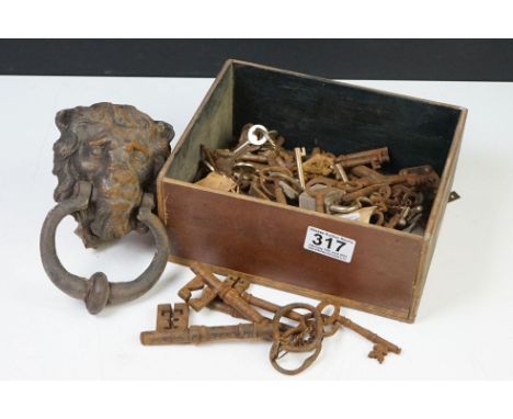 A collection of keys and padlocks together with a cast iron lion head door knocker. 