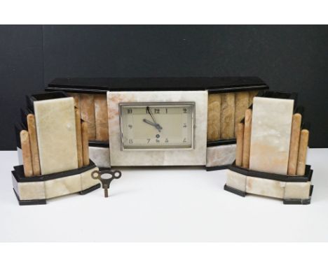 Art Deco marble &amp; black slate clock garniture of geometric architectural form, the clock with rectangular dial and Arabic