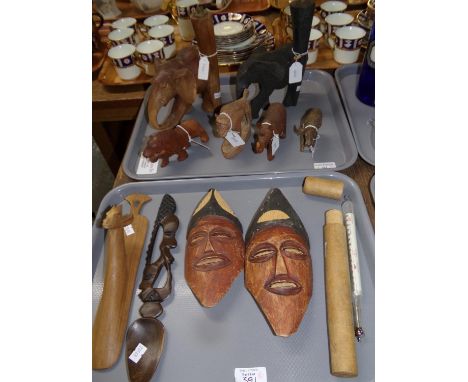 Two trays of carved tribal items: two elephant lamp stands, rhinoceros, lion, face masks etc. and a wooden case with a vintag