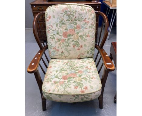 Ercol style stained beech stick backed armchair with loose floral cushions.  (B.P. 21% + VAT) 