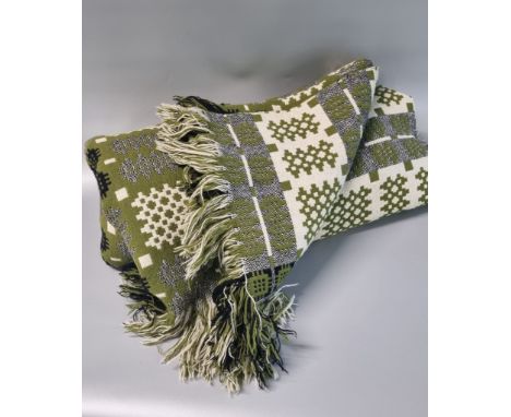 Vintage woollen Welsh tapestry green ground blankets; one olive green with fringed edges in traditional Carnarvon design.(B.P