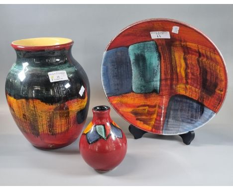 Three items of Poole pottery to include: Gemstones design shallow bowl, Harlequin design baluster vase and a Gemstones design