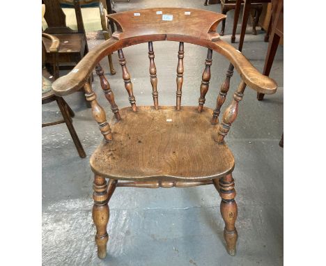 Early 20th century beech and elm smoker's bow armchair with saddle seat and baluster turned legs. (B.P. 21% + VAT)Structurall