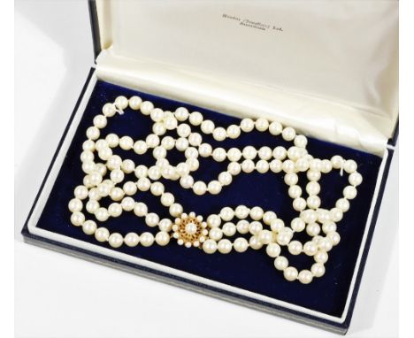 A graduated three row cultured pearl necklace, with 9ct gold clasp set with garnet and cultured pearls in a floral cluster, t
