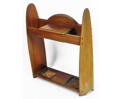 A 20thC mahogany aeroplane propeller stick stand, with propeller ends, central glove box and metal lined sections beneath, wi