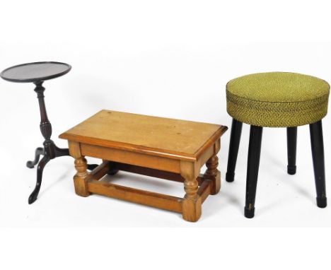 An early 20thC Arts and Crafts light oak stool, of rectangular form, the moulded top raised on squat turned supports and bloc