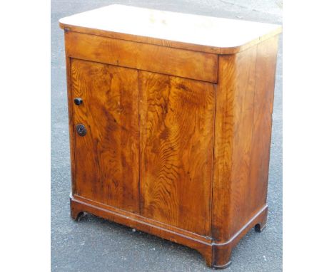 A Victorian walnut side cabinet, the rounded top raised above a single door, with shelf to the interior, on stylised bracket 