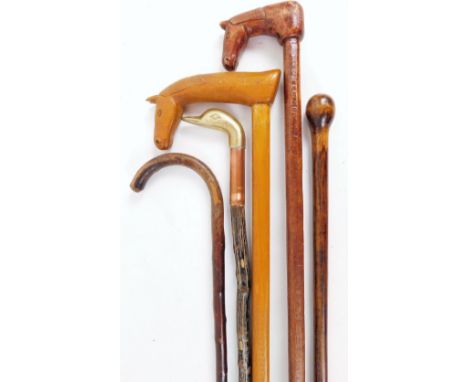 Various walking sticks, to include a carved horse head example, 87cm H, another with duck head, club style walking stick, etc