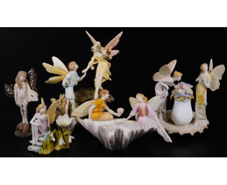 Various limited edition bisque fairy figures, to include fairy children holding hands on a naturalistic base, polychrome deco