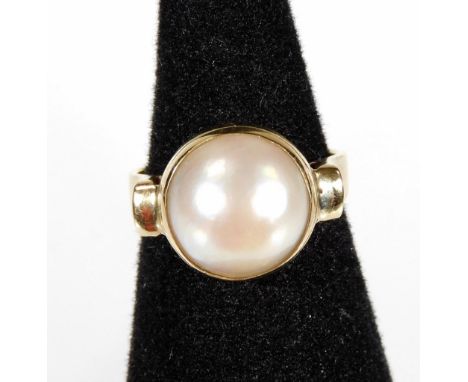 A 9ct gold cultured pearl dress ring, with circular half cultured pearl, in chunky gold setting, with raised shoulders, ring 