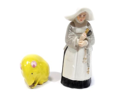 A late 19thC Royal Worcester nun candle snuffer, modelled in standing pose, 1892, 10cm H and a Royal Worcester miniature figu
