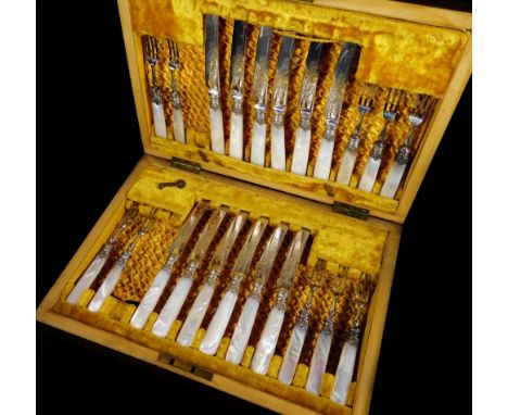 A set of Edwardian bright cut mother of pearl entree knives and forks, with silver collars, in fitted mahogany canteen, part 