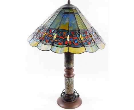 A Tiffany style lamp, with large shade decorated in coloured glass, on turned base lamp stand with two lights, on turned stem
