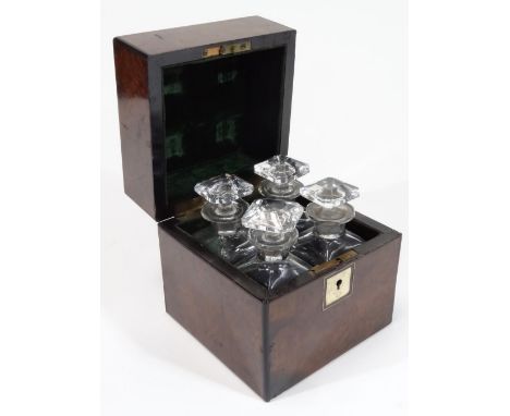 A late Victorian walnut decanter box, of square form, with vacant mother of pearl cartouche, the fitted interior set with fou