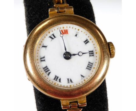 A 9ct gold wristwatch, with white enamel circular watch head, on expanding gold strap, with 17 jewel movement, the watch head