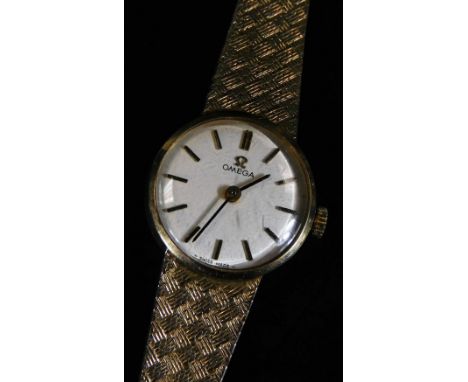 A ladies Omega 9ct gold cocktail watch, with textured bracelet and 2cm Dia. dial with baton numerals and pointers, 21g all in