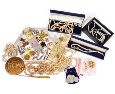 A large quantity of costume  jewellery, to include mainly faux pearl necklaces and varying straps, clip on earrings, compacts