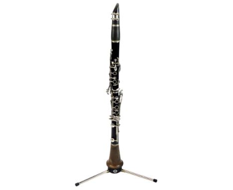 A 20thC clarinet, ebonised with chrome buttons, on a later KAM stand, 65cm H.