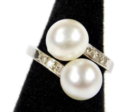 A cultured pearl and diamond twist ring, set with two silvered coloured cultured pearls, one to each twist, three diamonds to