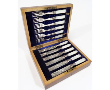 A set of early 20thC entree knives and forks, with mother of pearl handles and bright cut blades, with shaped collars, 16cm W