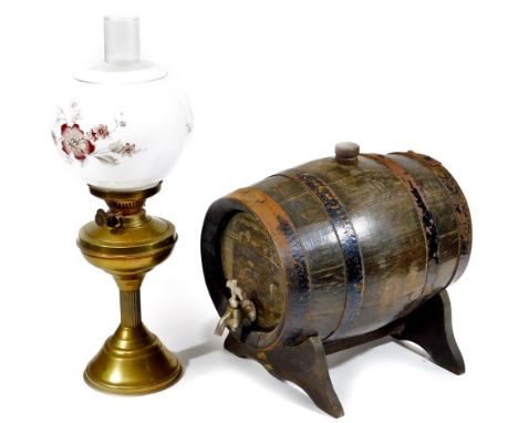 A 20thC brass oil lamp, with clear chimney, frosted glass shade decorated with flowers, with brass reservoir on fluted stem a