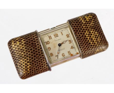 A silver and snakeskin cased Movado travel clock, marked Ermeto, with slide out snakeskin covered sides, Swiss movement, numb