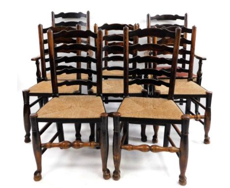 A set of eight Lancashire ash ladder back chairs, each with a rush seat, turned stretchers and shaped legs with pad feet, two