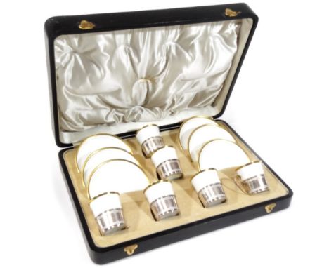 A cased set of six Shelley late Foley gilt rimmed coffee cups and saucers, by Mappin &amp; Webb, with silver mounts, loop han