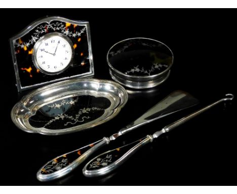 A George V silver and tortoiseshell part dressing table set, comprising of a travel clock, with 4.5cm Dia. Arabic dial, marke