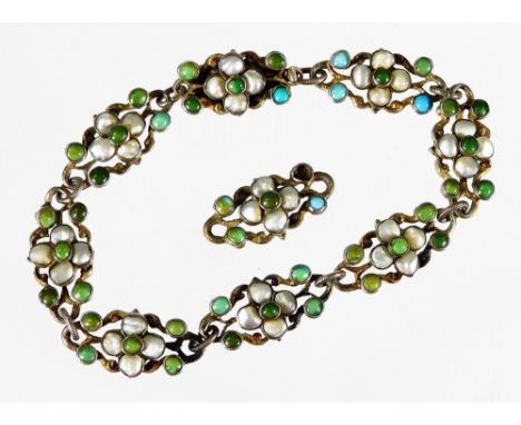 A continental design bracelet, set with turquoise and pearl decoration, in floral cluster type design, on a silver coloured b