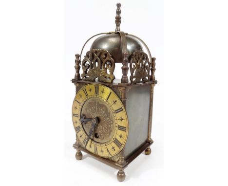 A 20thC Empire lantern clock, of rectangular form with bell top and 12cm Dia. Roman numeric dial, on turned feet, 27cm H. 