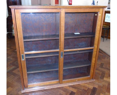 Mid 20th century light oak cabinet with two glazed sliding doors Condition reports not available for this auction